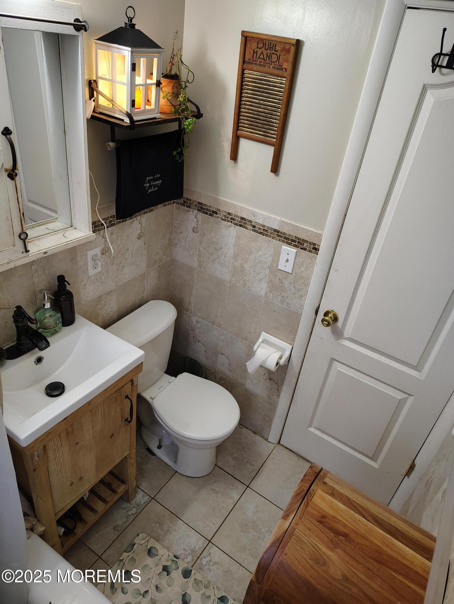 434 Shady Lane Howell, NJ 07731 - Photo 14 of 15 a bathroom with a toilet sink and mirror
