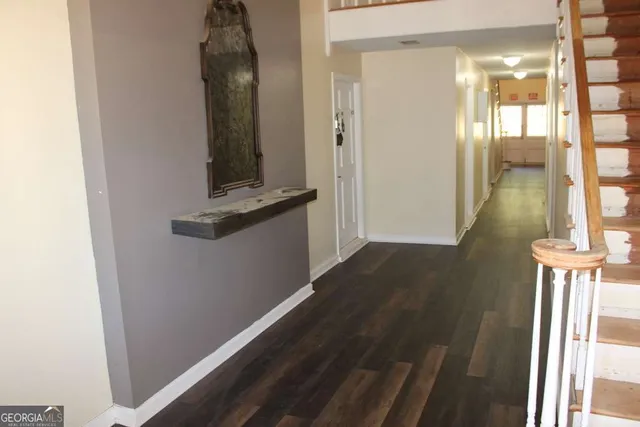 a view of a hallway with wooden floor