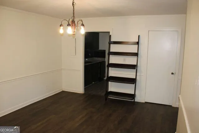 a view of a room with wooden floor and windows