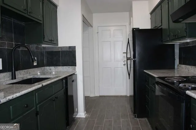 a kitchen with a sink and refrigerator