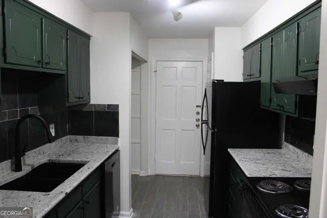 a kitchen with a refrigerator and a sink