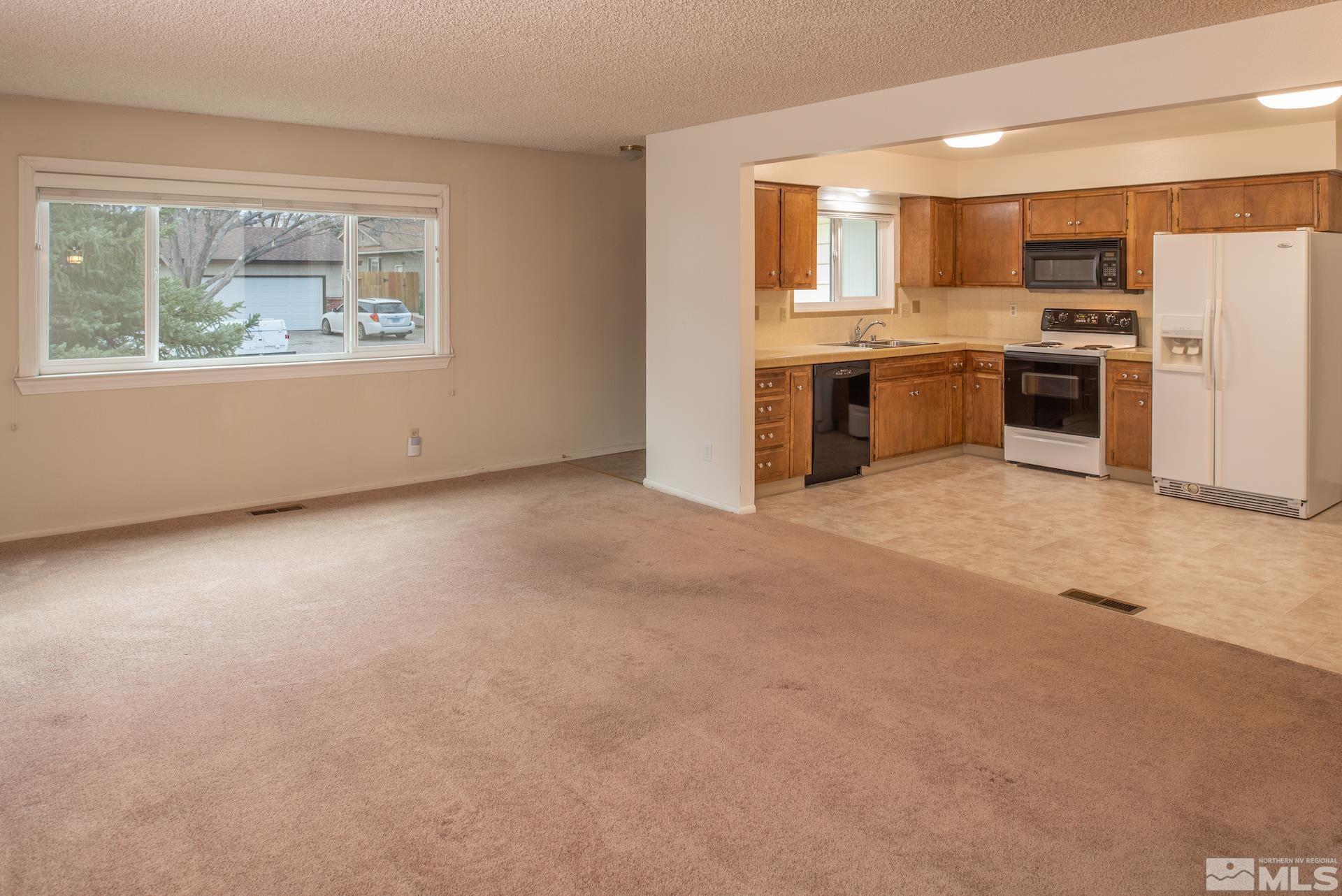 2055 Prince Way Reno, NV 89503 - Photo 2 of 35 a view of a kitchen with a sink stove and a refrigerator
