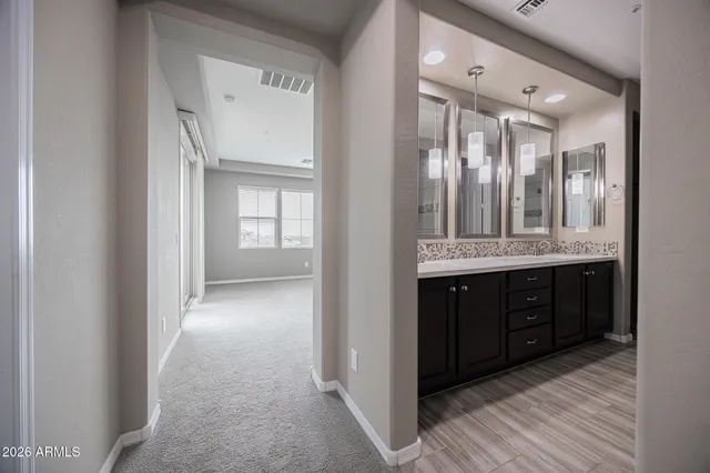 a bathroom with a double vanity sink and mirror