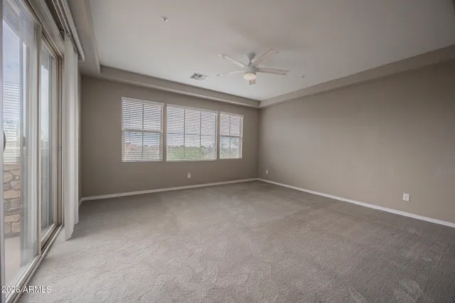 an empty room with a empty space and windows