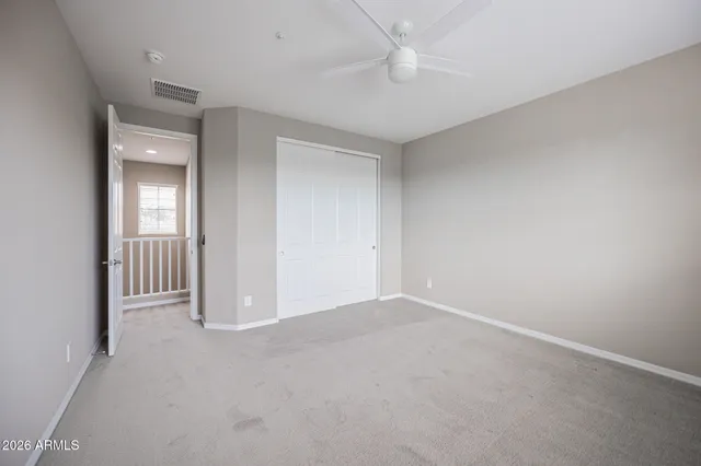 an empty room with a empty space and a ceiling fan