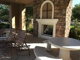 a living room with furniture a fireplace and a potted plant