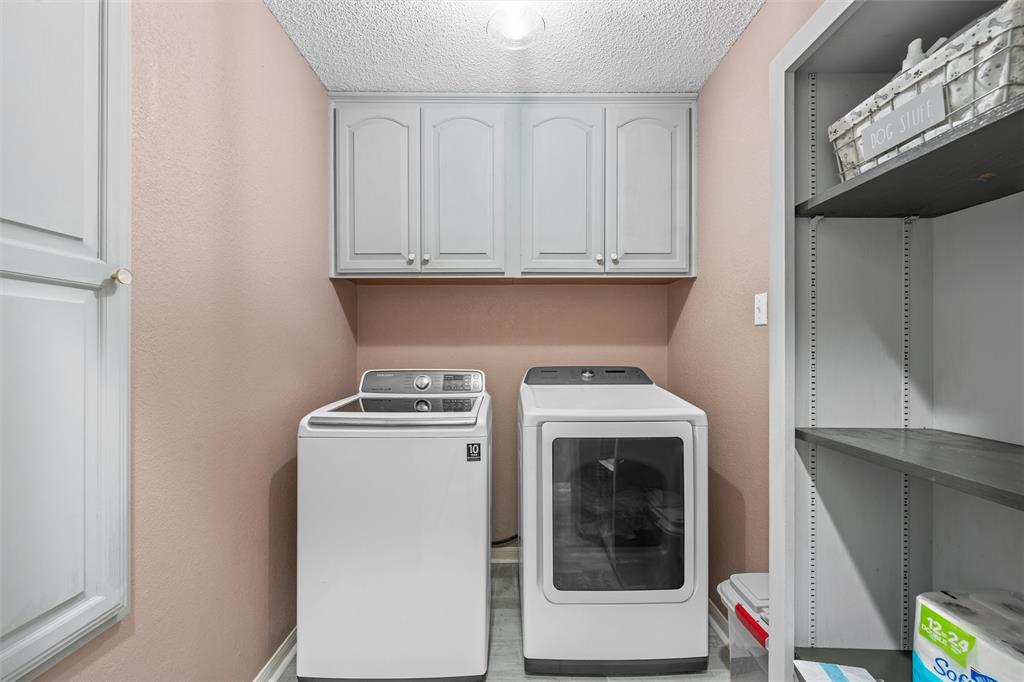 112 Briar Ridge Drive Hewitt, TX 76643 - Photo 13 of 15 Dedicated laundry area featuring upper cabinetry with light gray finishes, a built-in storage closet with shelving, and a textured ceiling