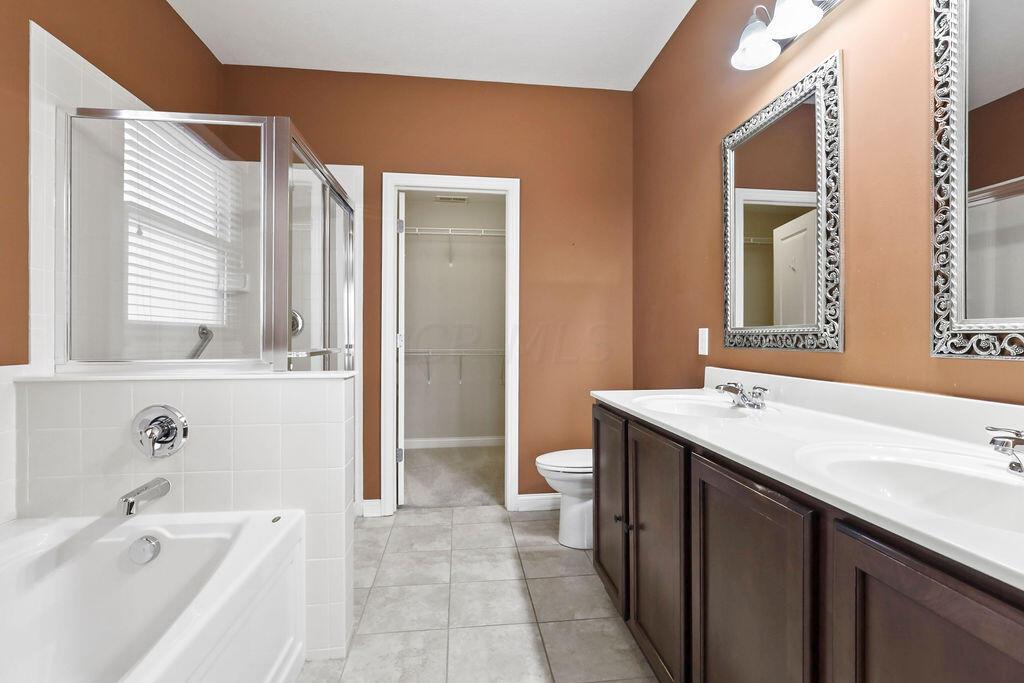 6163 Jennis Road Westerville, OH 43081 - Photo 18 of 44 • Ceramic tile flooring
• Paprika painted walls
• Enclosed vanity with double
bowl, cultured marble sinktop
• Garden tub with ceramic tile
surround
• Shower stall with glass
enclosure & ceramic tile
surround
• Ceiling exhaust
• 5 bulb wall light
• Mirrored medicine cabinet
• 2” blinds