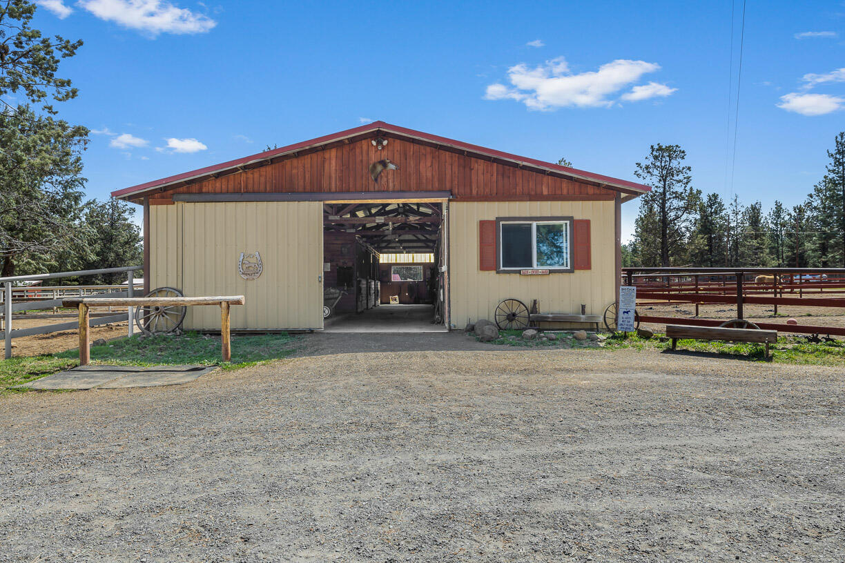 67500 Harrington Loop Road Bend, OR 97703 - Photo 36 of 72 a view of a house with backyard and a tree