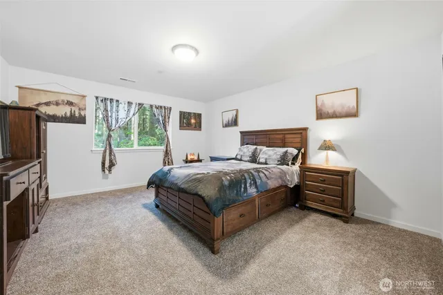 a bedroom with a bed and a television