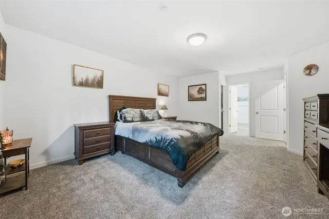 a bedroom with a bed and a tv