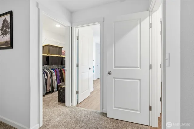 a view of walk in closet with clothes