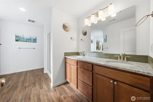 a bathroom with a granite countertop sink mirror and vanity