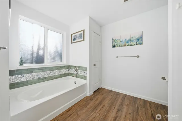 a bathroom with a bathtub and a shower