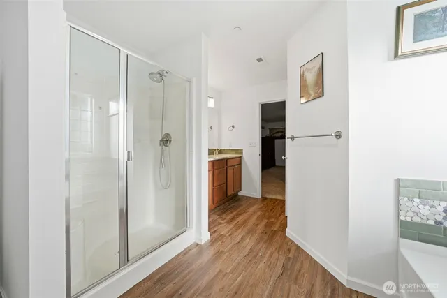 a view of a hallway with wooden floor and staircase