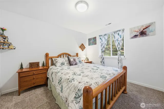 a bed sitting in a bedroom next to a window