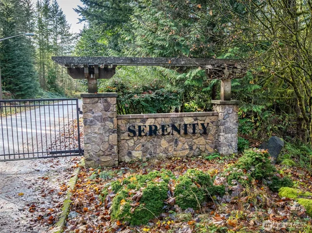 a view of a yard with wooden fence