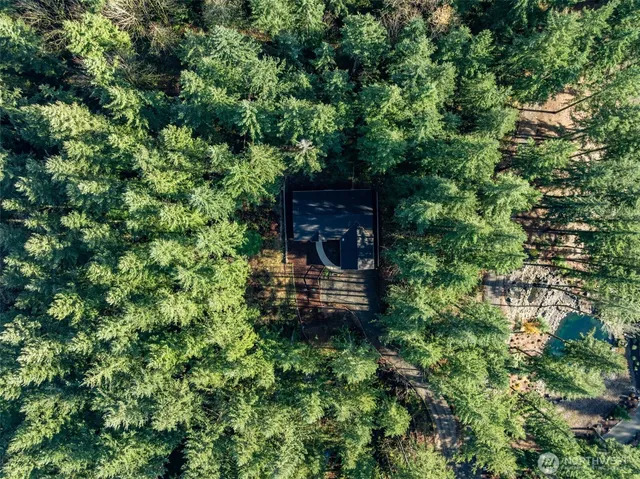 an aerial view of a house with a yard