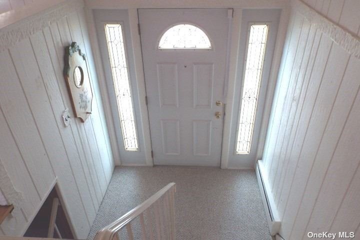 a view of a hallway with windows and stairs