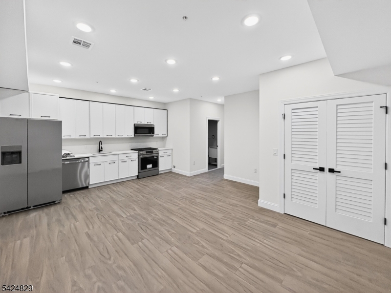 262 Hunterdon Street, Unit 1 Newark, NJ 07103 - Photo 2 of 31 a view of kitchen with wooden floor and electronic appliances