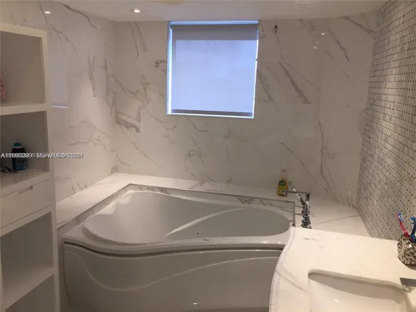 a bathroom with a tub and sink