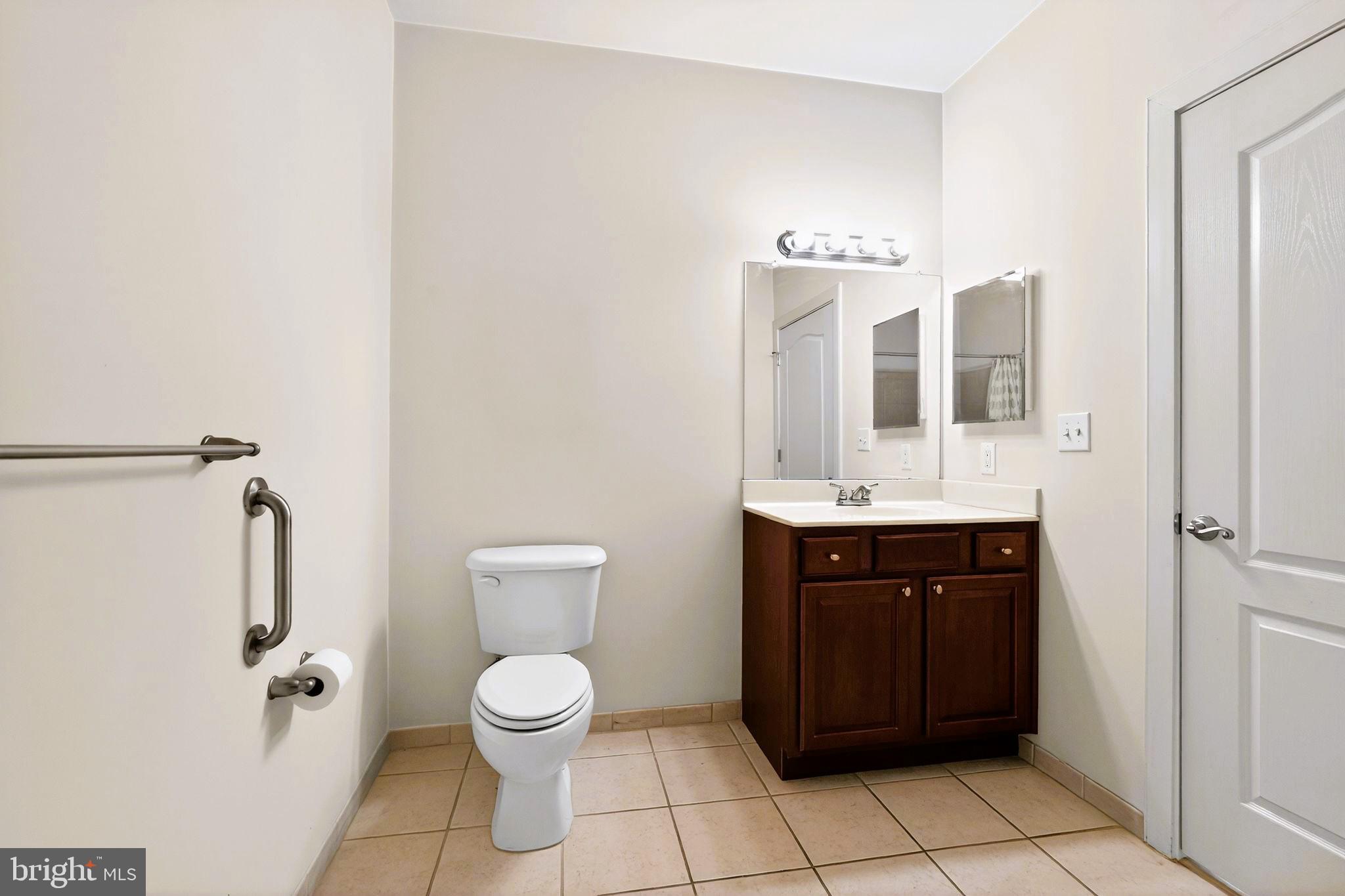 1630 Welsh Road, Unit 5A Philadelphia, PA 19115 - Photo 14 of 27 a bathroom with a toilet sink and mirror