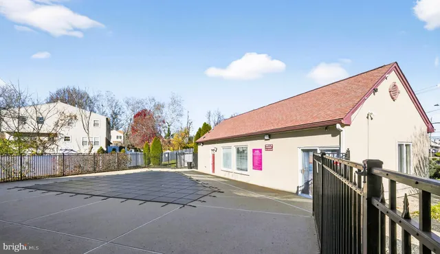 a view of a house with a yard patio and fire pit