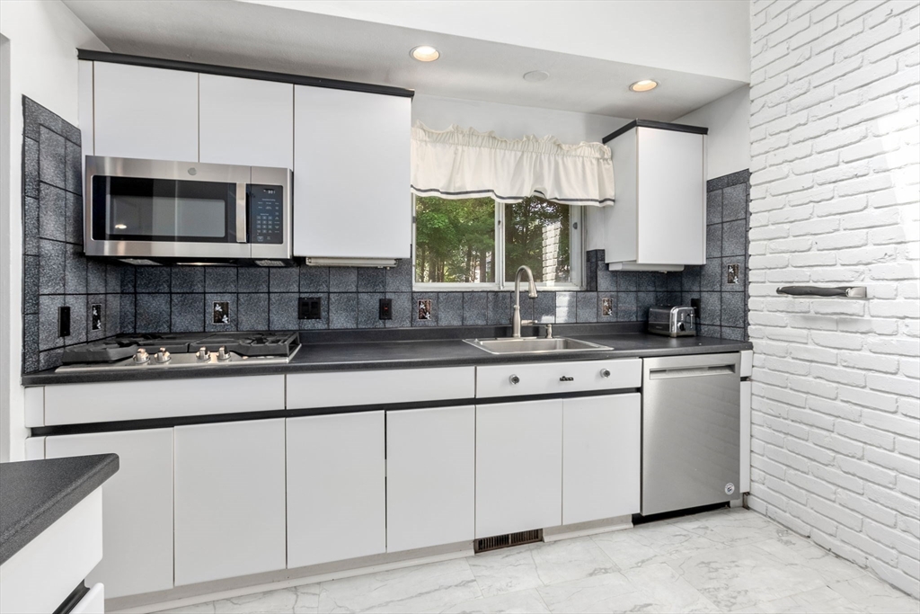 372 Old Connecticut Path Framingham, MA 01701 - Photo 13 of 33 a kitchen with stainless steel appliances granite countertop a sink a stove a microwave and cabinets