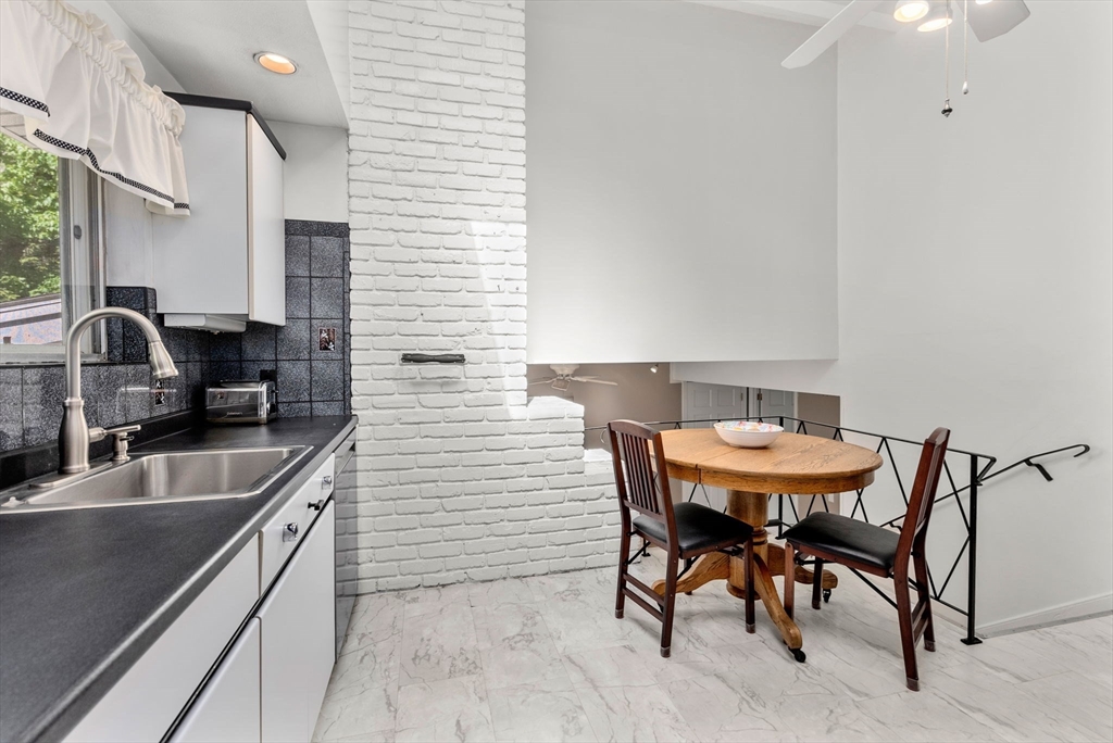 372 Old Connecticut Path Framingham, MA 01701 - Photo 15 of 33 a kitchen with a table chairs and a sink