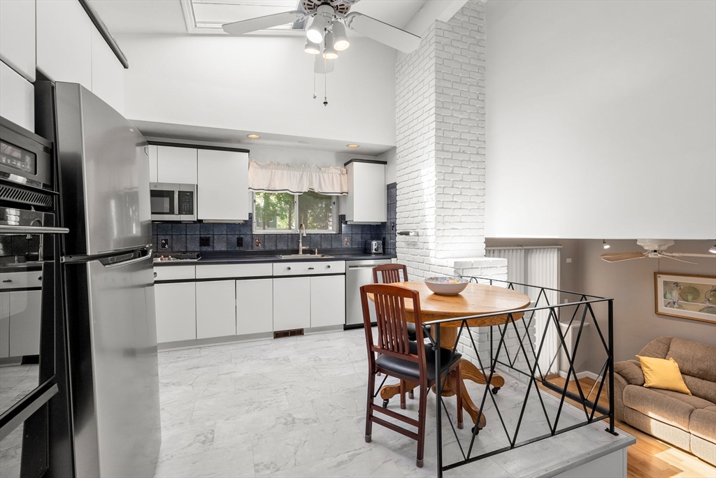 372 Old Connecticut Path Framingham, MA 01701 - Photo 16 of 33 a kitchen with stainless steel appliances kitchen island granite countertop a sink and cabinets
