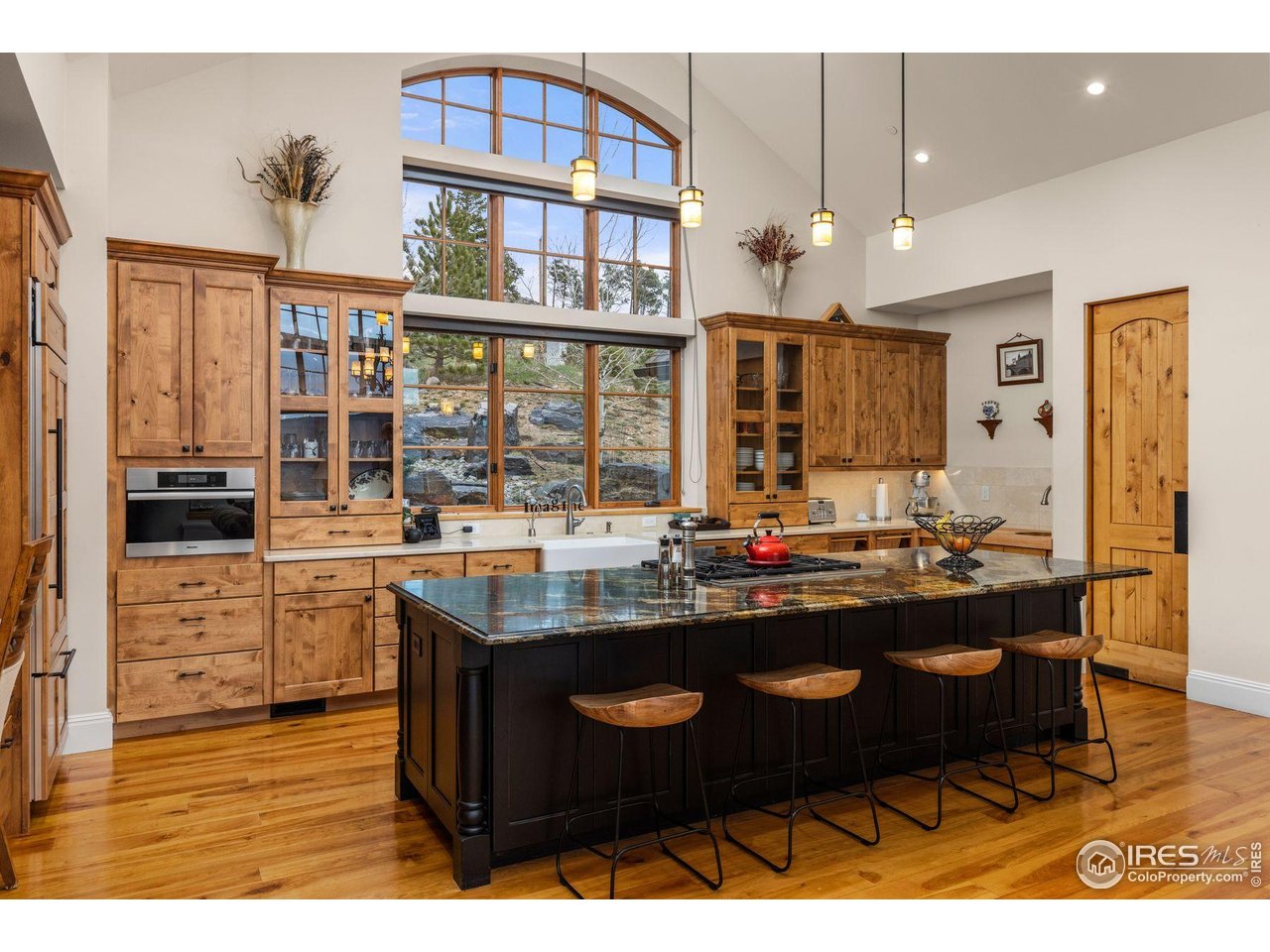 750 Left Fork Road Boulder, CO 80302 - Photo 13 of 39 a kitchen with kitchen island granite countertop a sink cabinets and stainless steel appliances