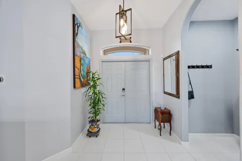 a view of a dining room with furniture a chandelier and wooden floor
