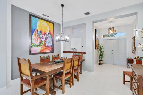 a living room with furniture a flat screen tv and a large window