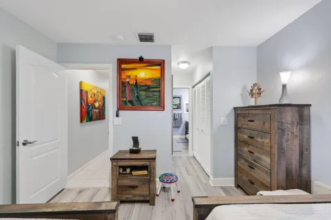 a living room with patio furniture and a potted plant
