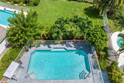 a kitchen with stainless steel appliances kitchen island wooden cabinets and a sink