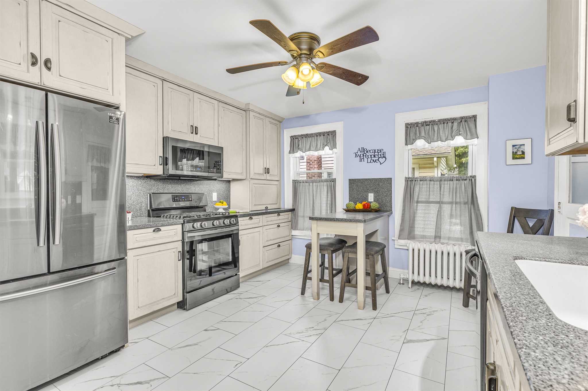 22 Pine Street Pine Plains, NY 12567 - Photo 14 of 25 a kitchen with stainless steel appliances granite countertop a stove a refrigerator a oven a sink with a dining table and chairs