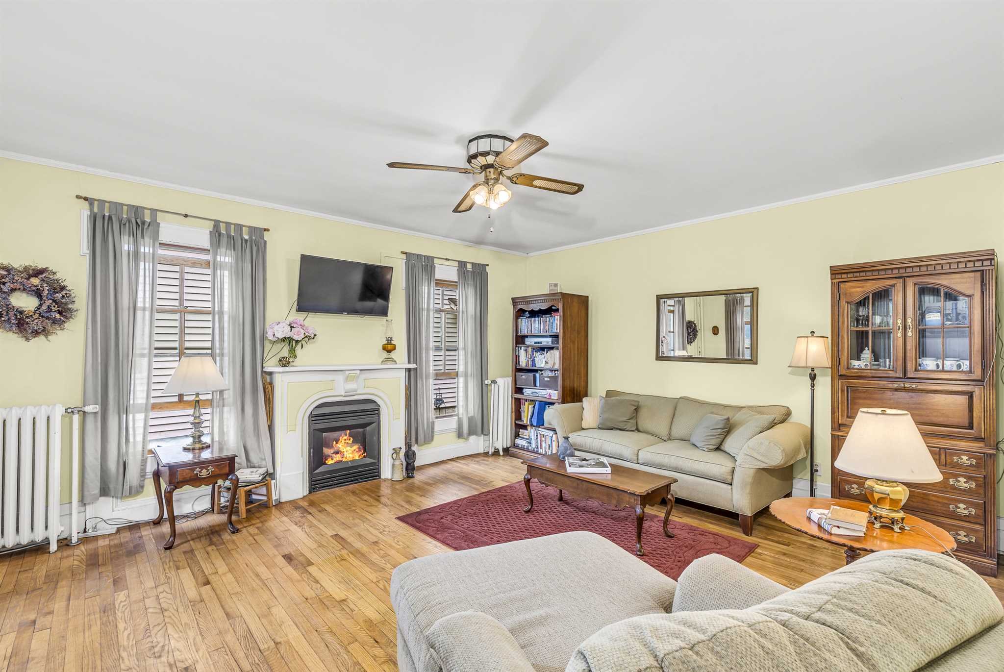 22 Pine Street Pine Plains, NY 12567 - Photo 7 of 25 a living room with furniture a fireplace and a flat screen tv