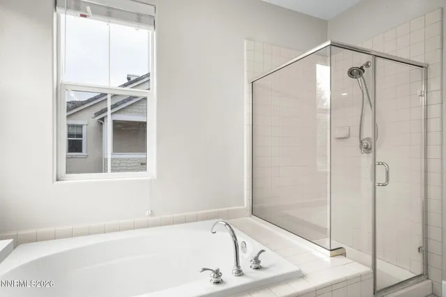 a bathroom with a bathtub and a shower