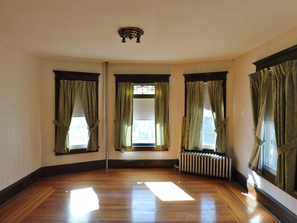 44-46 Langdon Street Springfield, MA 01104 - Photo 11 of 30 an empty room with wooden floor and windows