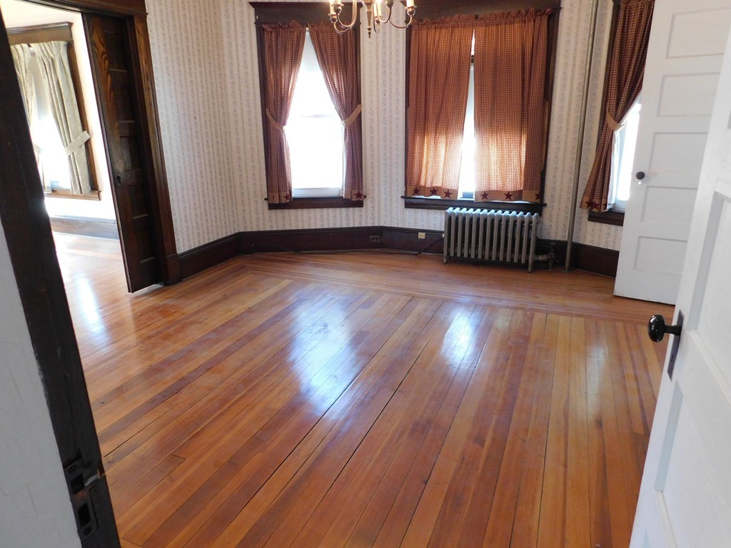 44-46 Langdon Street Springfield, MA 01104 - Photo 12 of 30 an empty room with wooden floor and windows