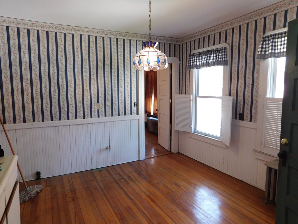 44-46 Langdon Street Springfield, MA 01104 - Photo 13 of 30 a view of an empty room with wooden floor and a window