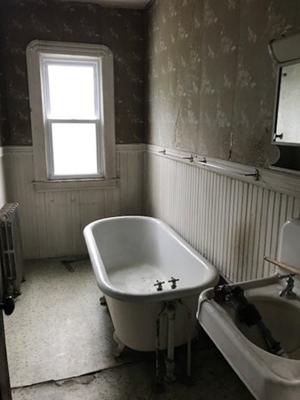 44-46 Langdon Street Springfield, MA 01104 - Photo 19 of 30 a bath tub sitting in a bathroom next to a window