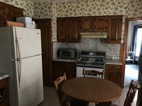 44-46 Langdon Street Springfield, MA 01104 - Photo 6 of 30 a kitchen with a refrigerator a stove a sink and cabinets