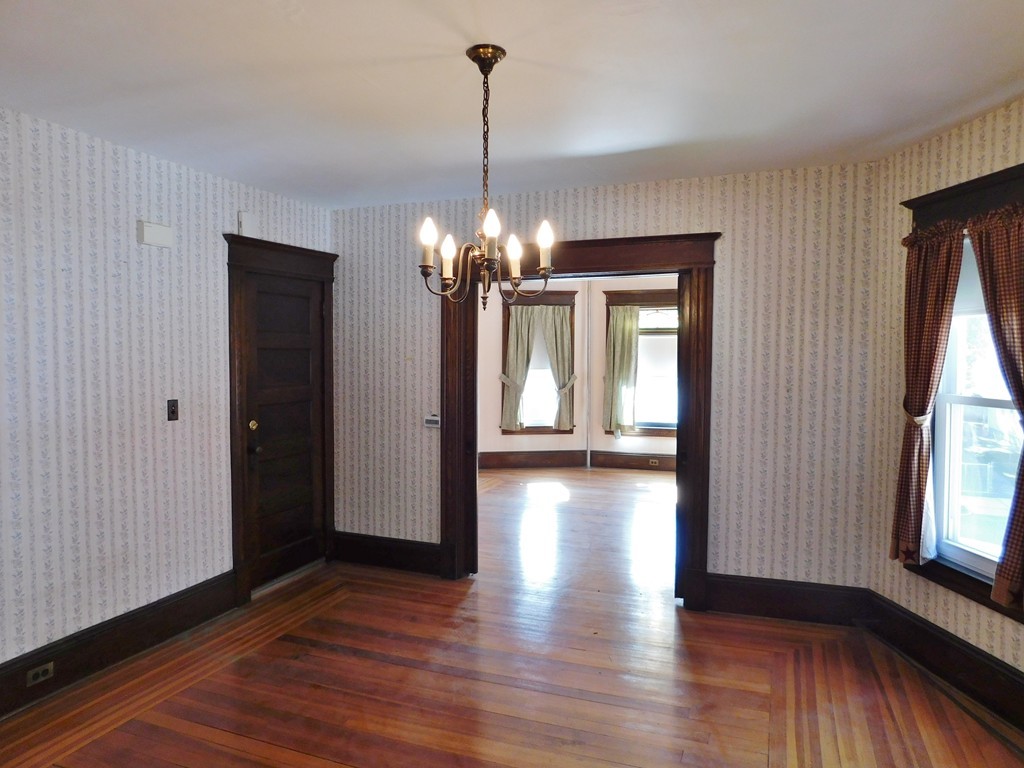 44-46 Langdon Street Springfield, MA 01104 - Photo 10 of 30 a view of a room with wooden floor chandelier and windows
