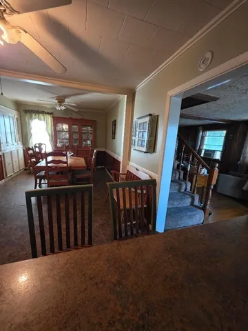 a view of a livingroom with furniture and staircase