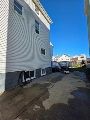 a view of a house with backyard and deck