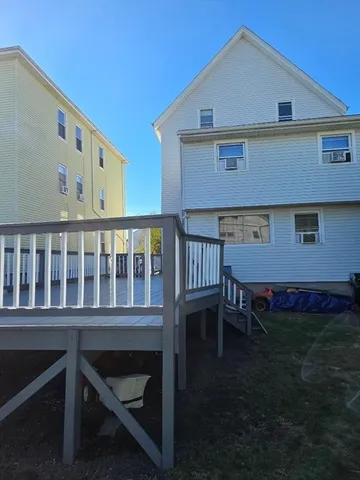 a view of a balcony with chair and wooden floor