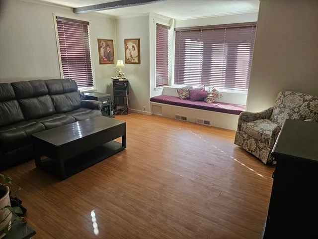 a bedroom with furniture and a window