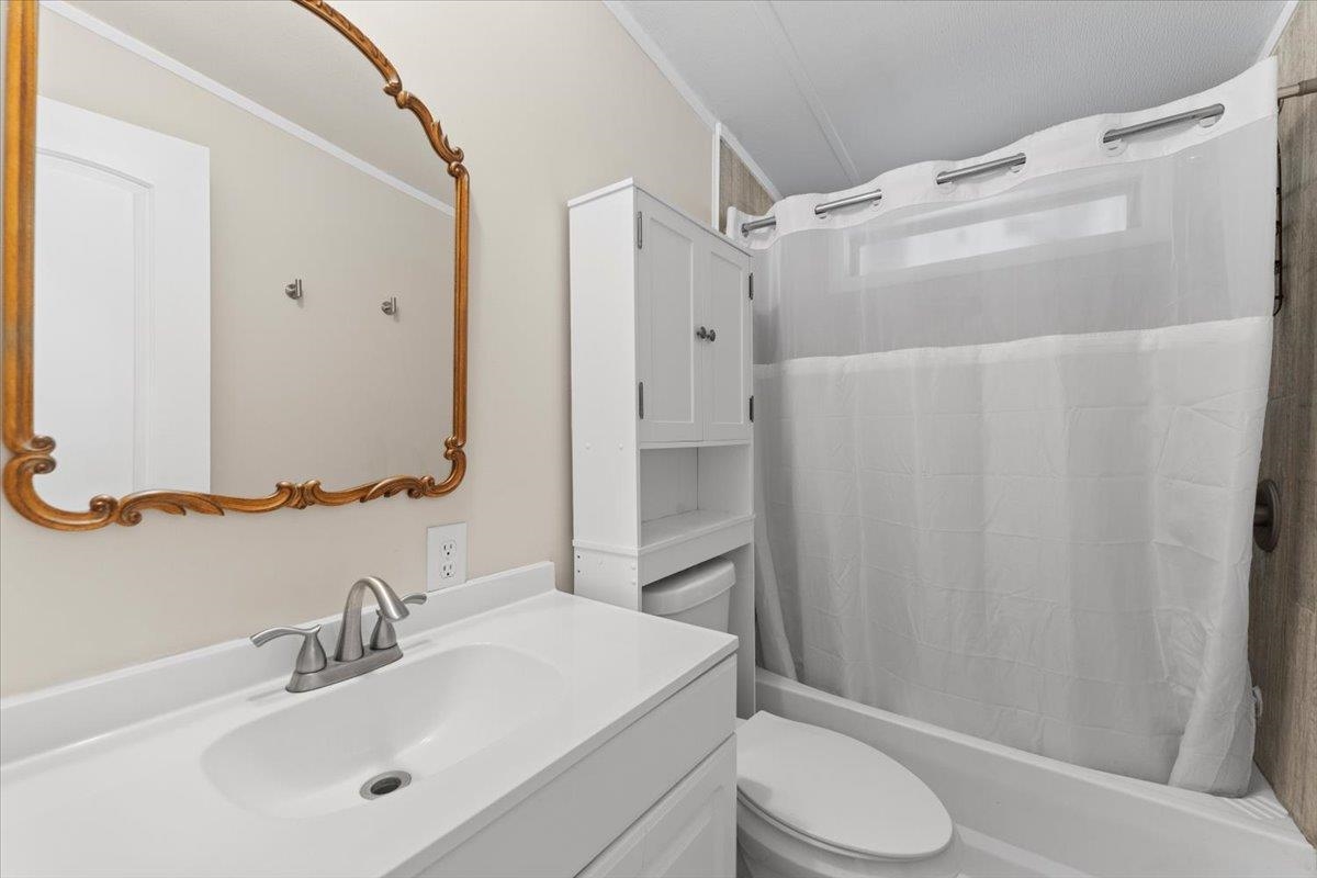 6860 Catlett Road St. Augustine, FL 32095 - Photo 18 of 36 Bathroom with vanity, shower / bath combo, and crown molding