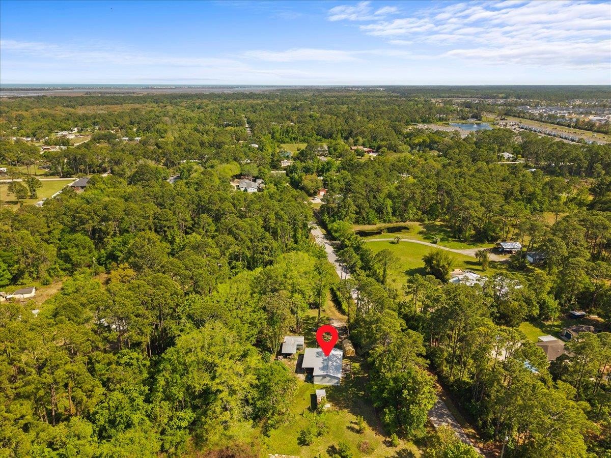 6860 Catlett Road St. Augustine, FL 32095 - Photo 31 of 36 Aerial view of a heavily wooded area and a large body of water